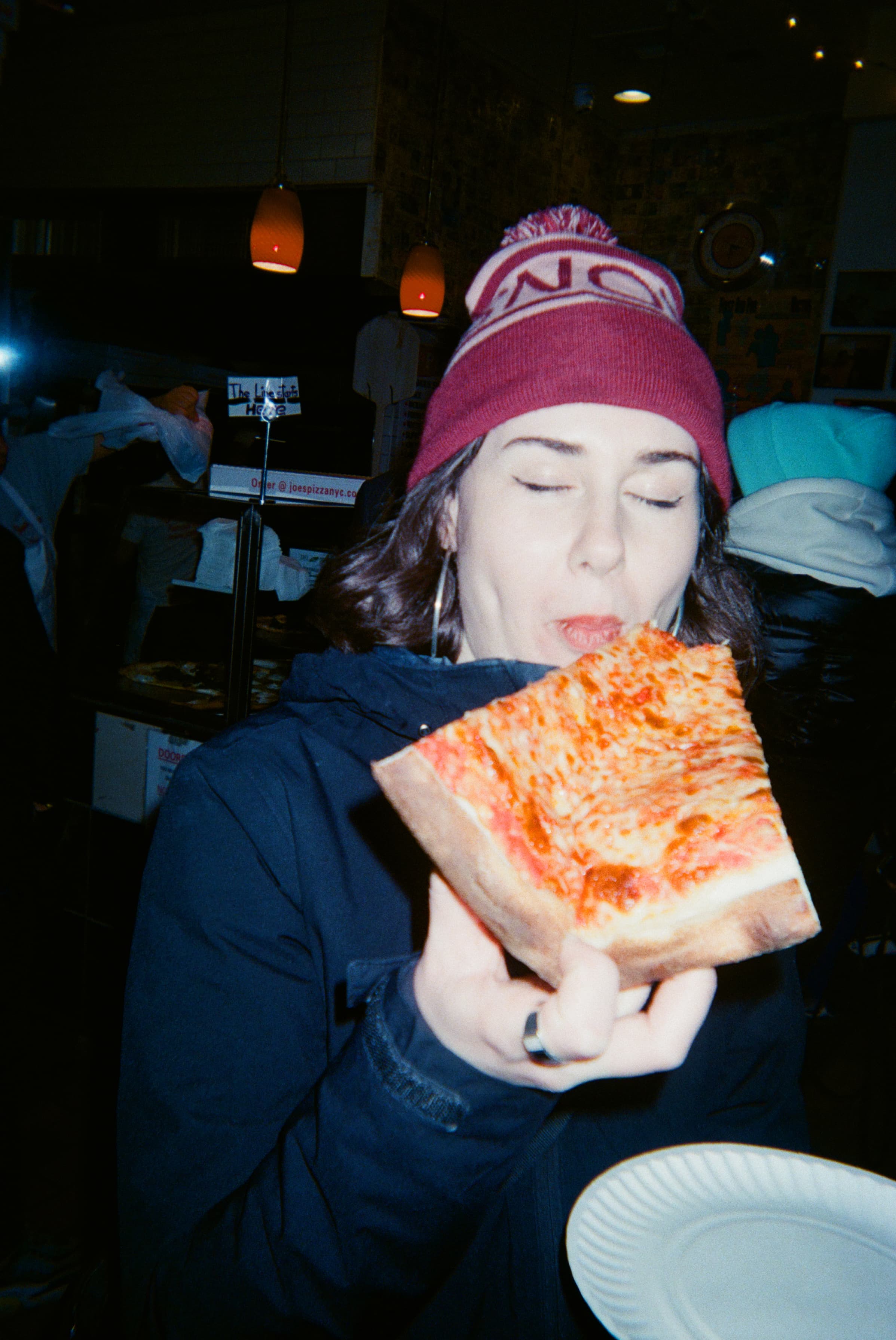A person eating a slice of pizza.