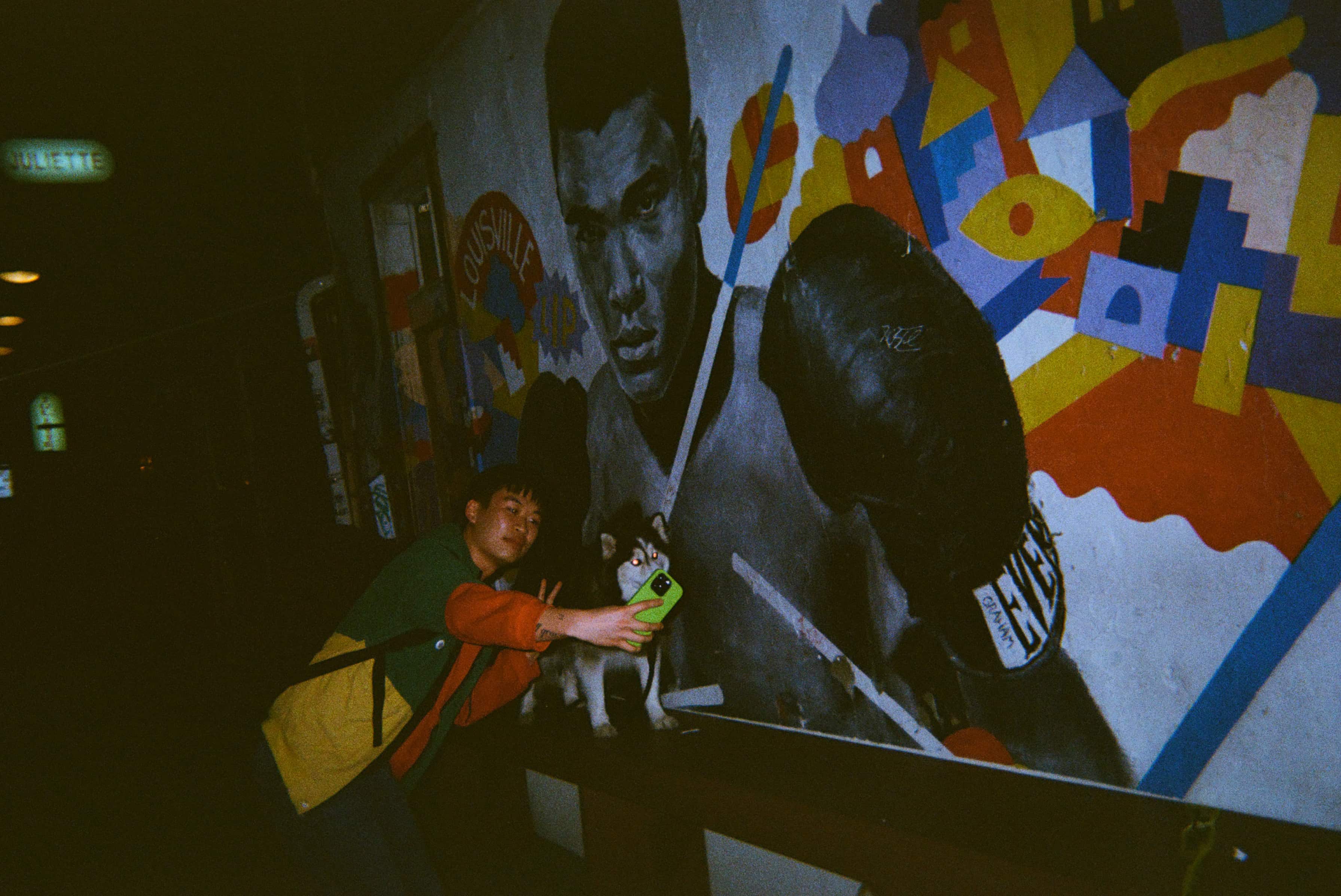 A person taking a selfie with a dog.