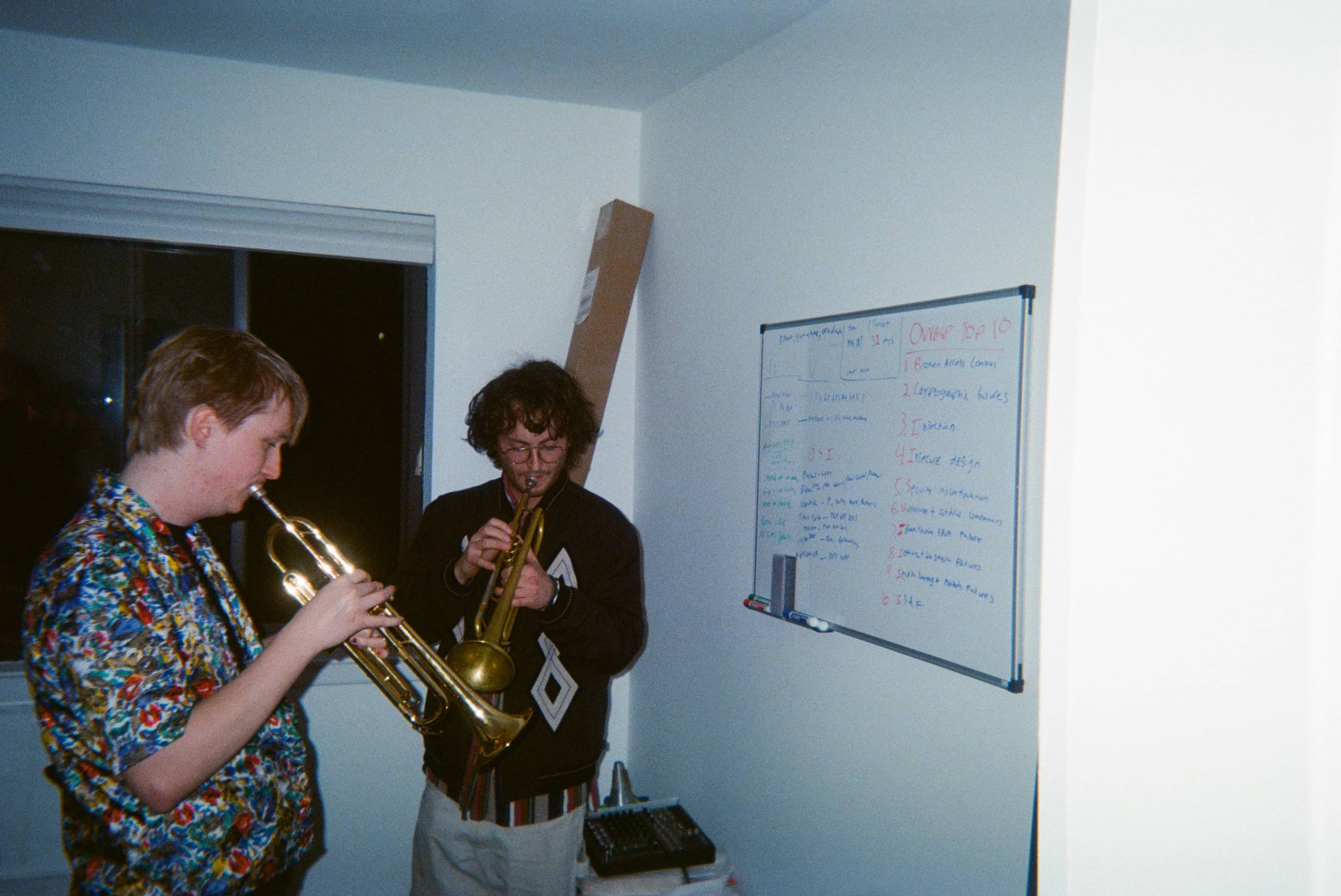 Two people playing trumpets.