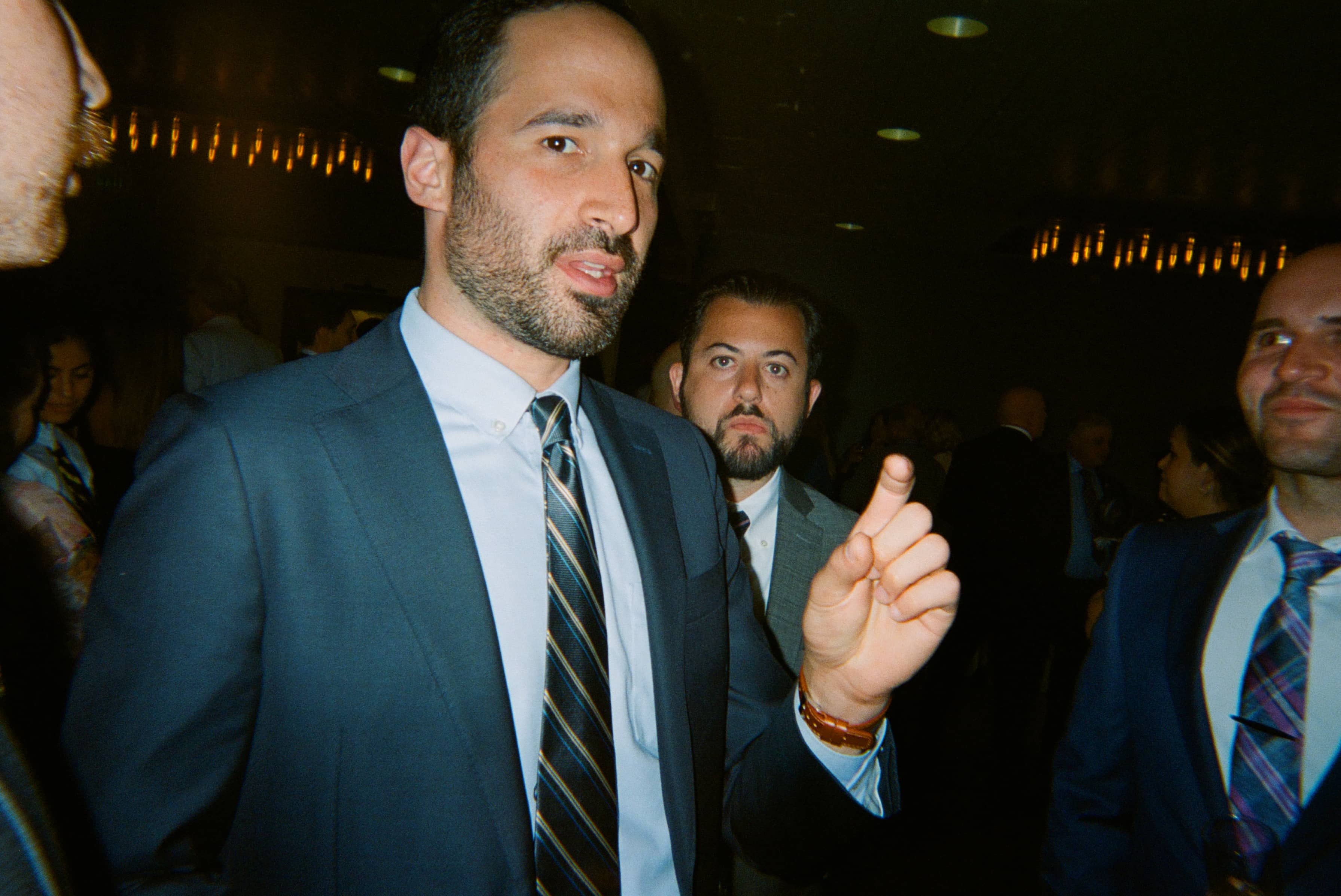 A man in a suit pointing his finger.