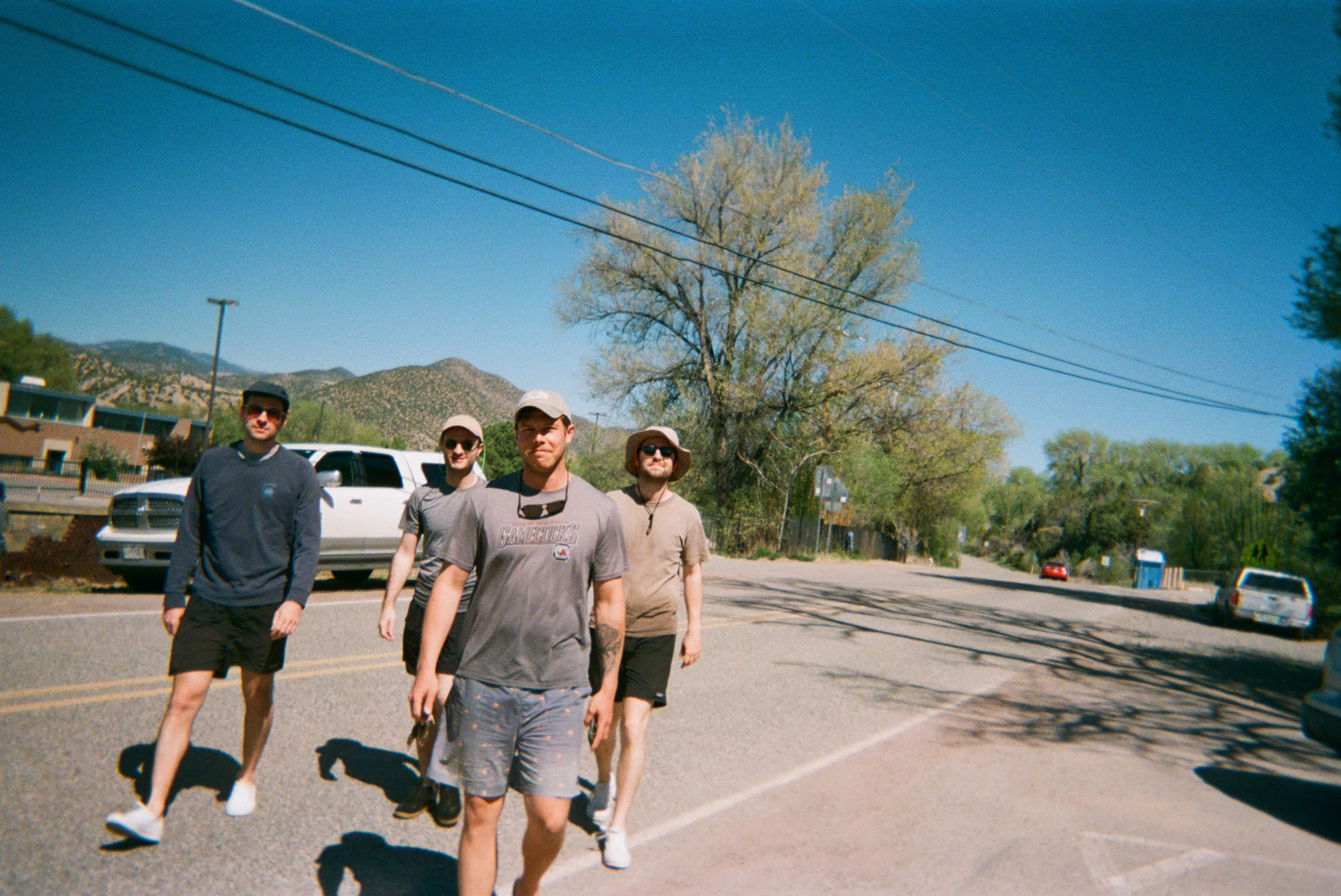 A group of men walking down a road.