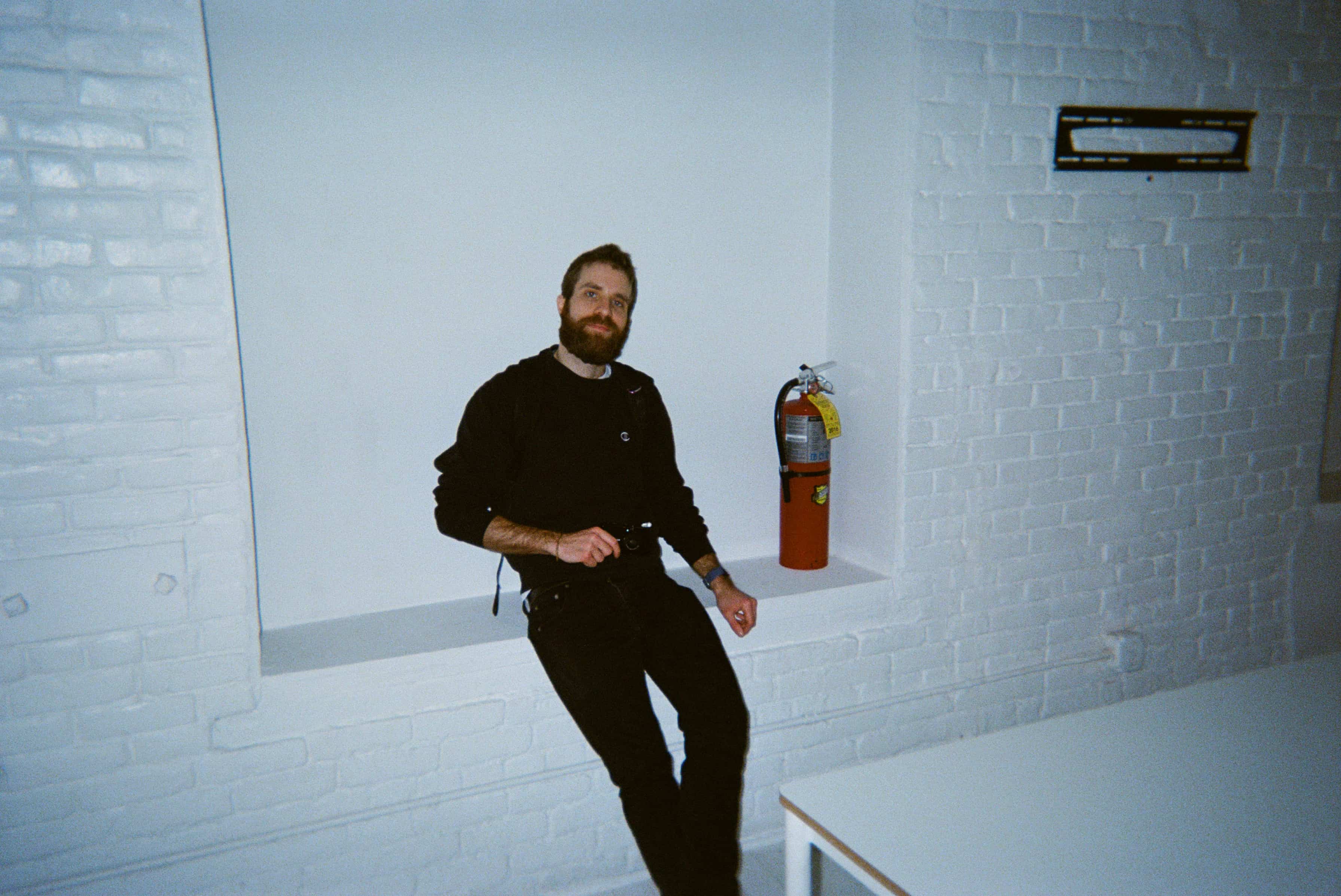 A person sitting on a ledge.