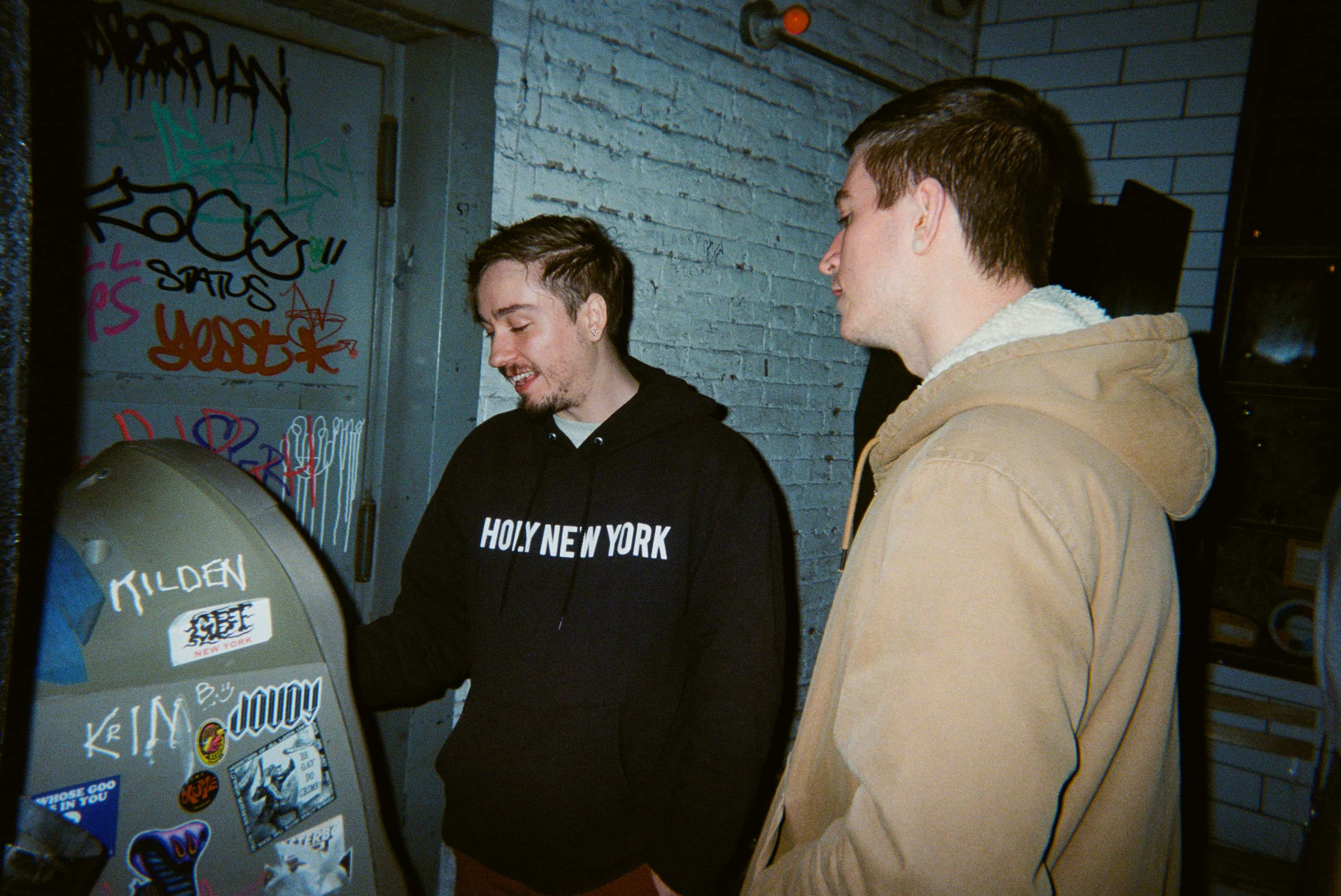 A group of men standing next to an ATM.