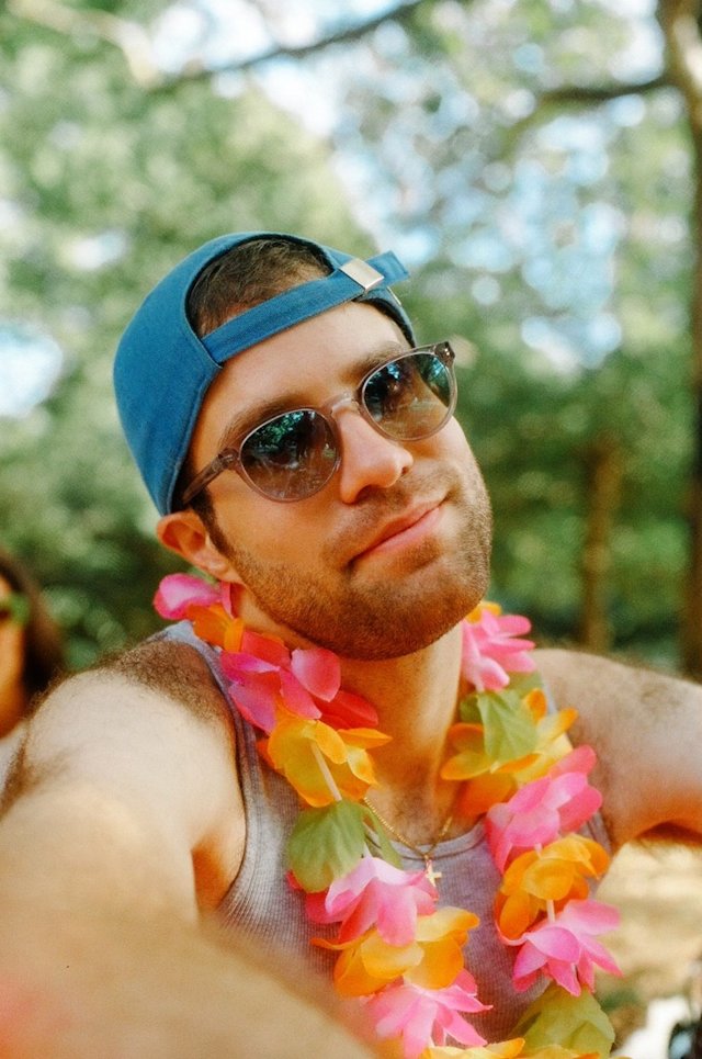 Person in blue hat in a park during summer.
