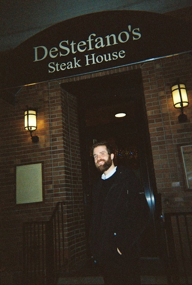 Person standing outside steakhouse in Brooklyn.
