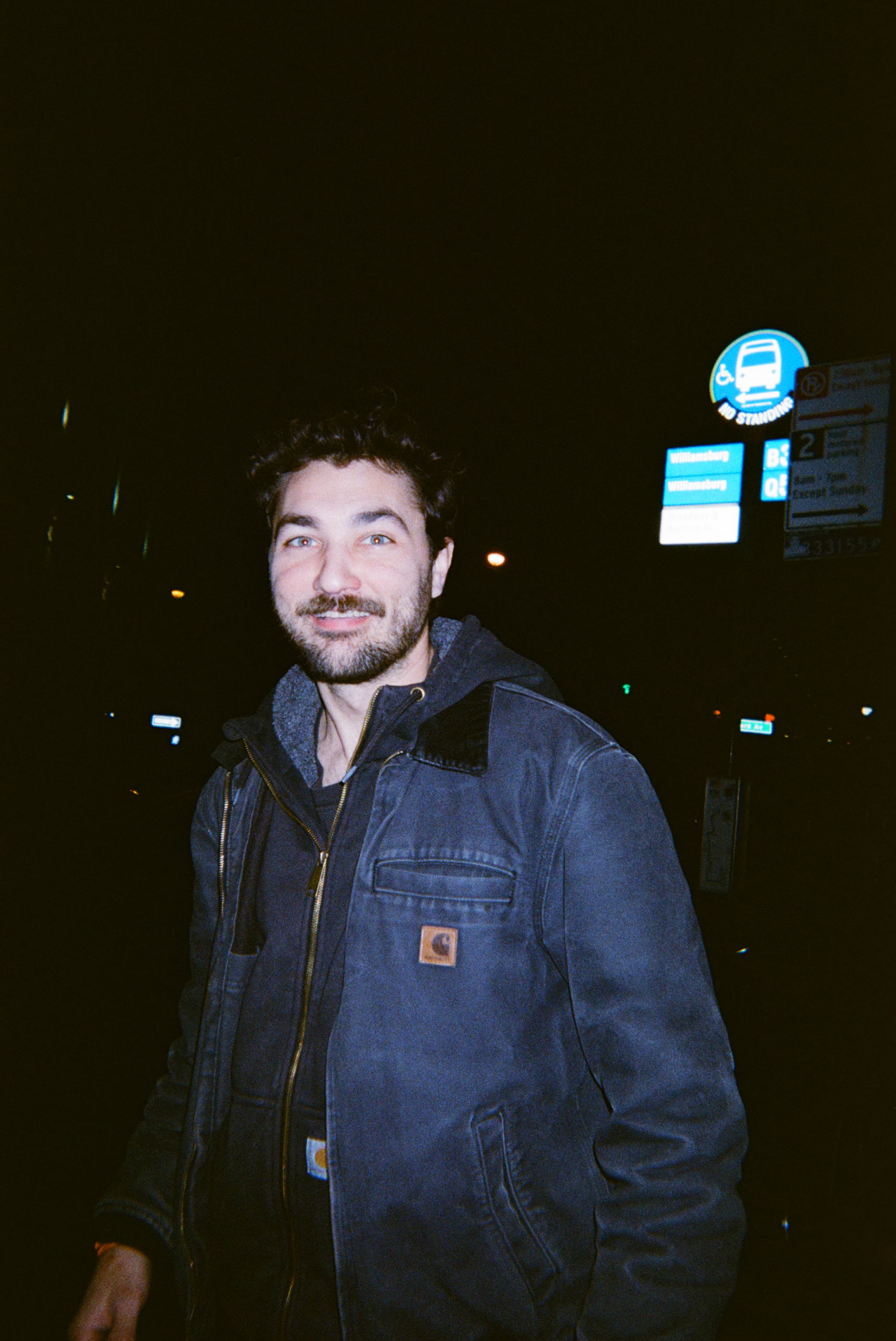 A person standing outside at night.