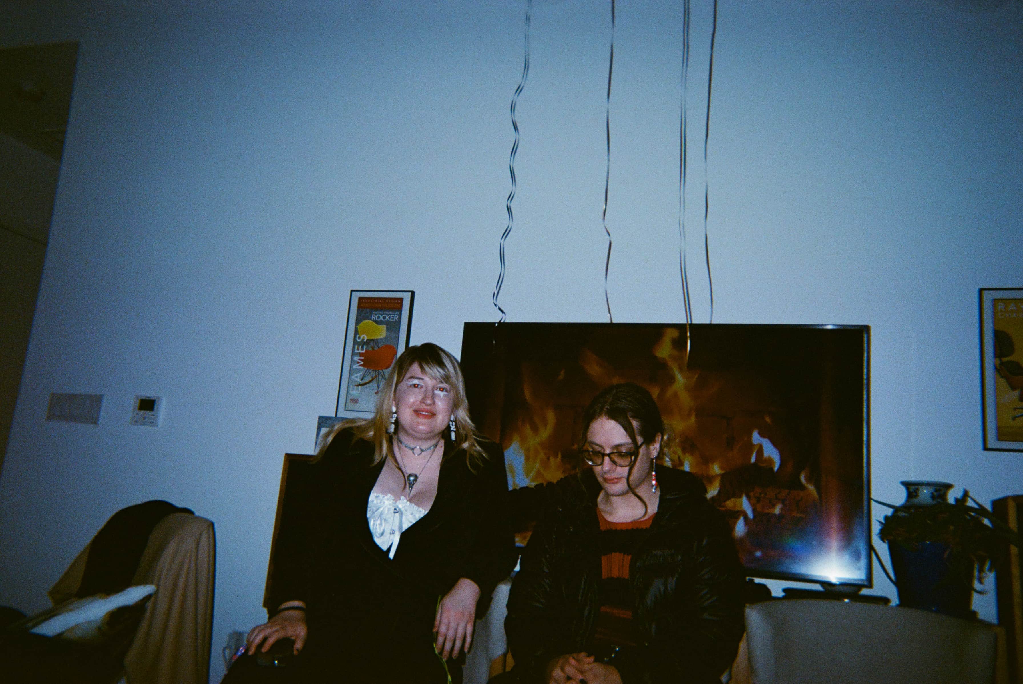 Two women sitting on a couch.