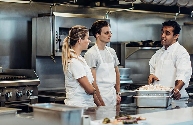Millennials learning from a chef.