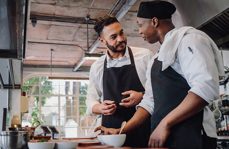 Two employees talking in the kitchen