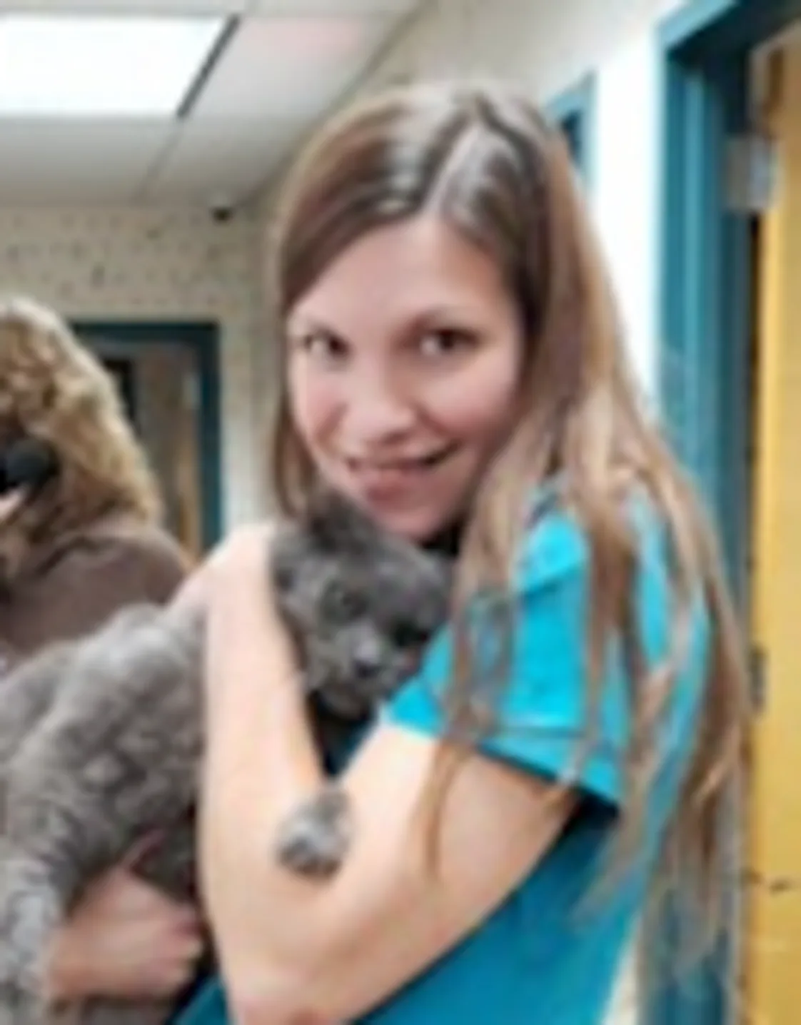 Melissa Gillen's staff photo from Shinnecock Animal Hospital where she is holding a grey cat in her arms. Melissa Gillen's staff photo from Shinnecock Animal Hospital where she is holding a grey cat in her arms.