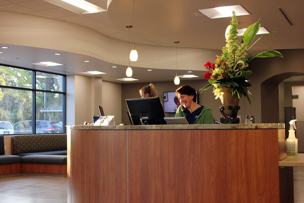 A view of our front desk with staff taking calls