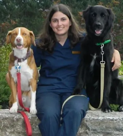 Ginny sitting with her two dogs, Rusty and Vera Ginny sitting with her two dogs, Rusty and Vera