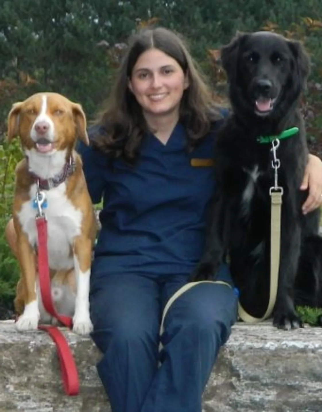 Ginny sitting with her two dogs, Rusty and Vera Ginny sitting with her two dogs, Rusty and Vera