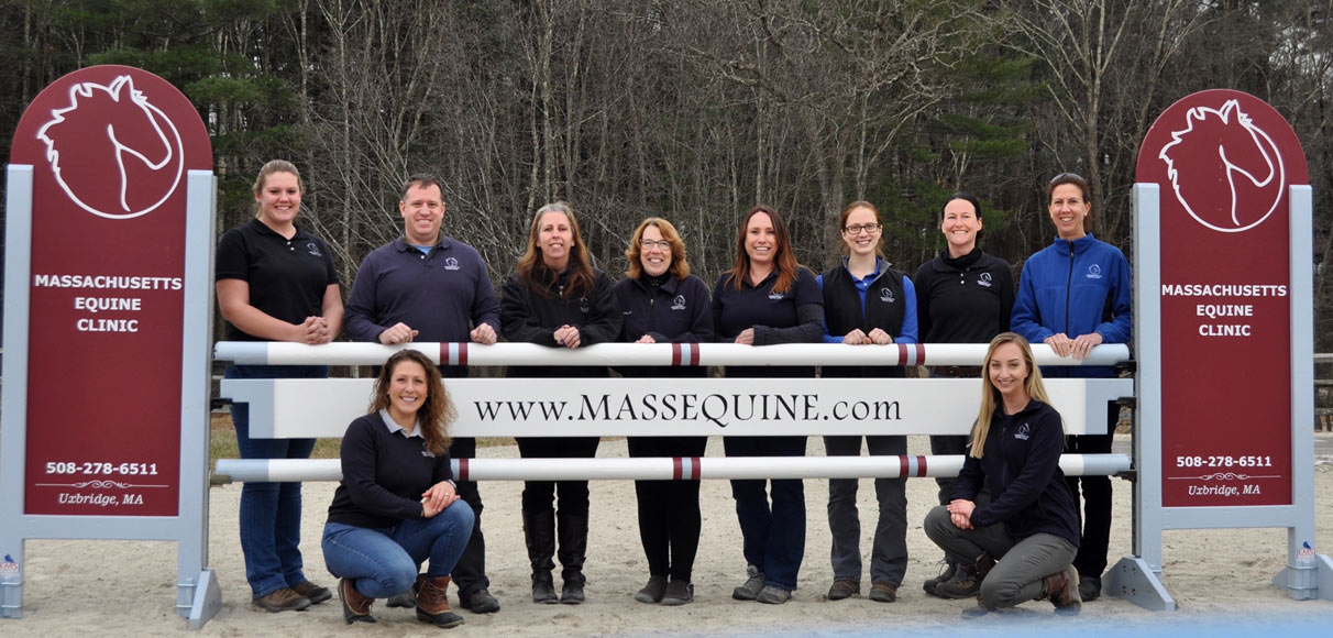 Staff standing by Mass Equine sign
