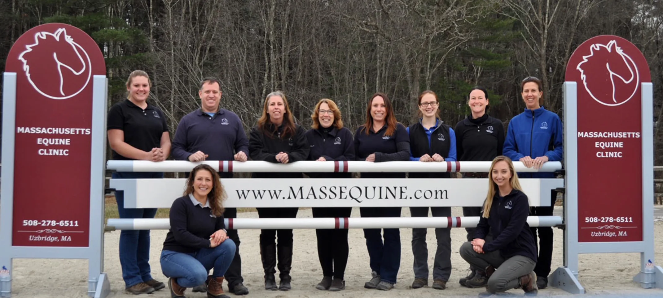 Staff standing by Mass Equine sign Staff standing by Mass Equine sign
