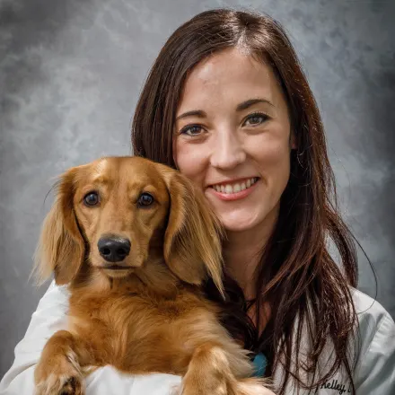 Dr. Kelley holding a dachshund