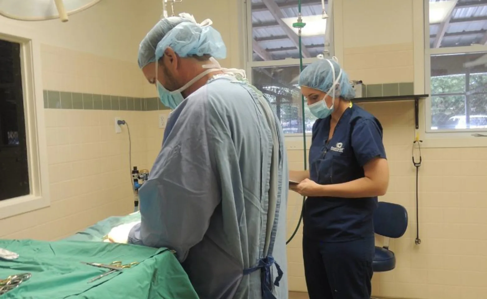 Photo of two doctors performing surgery Photo of two doctors performing surgery