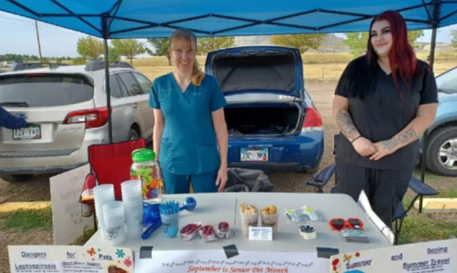 Two staff members promoting pet health