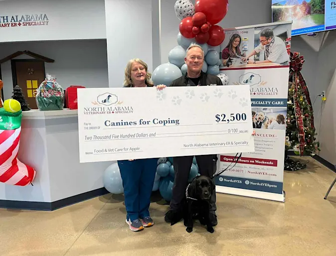 Two people holding a large check in NAVES' front office. Two people holding a large check in NAVES' front office.