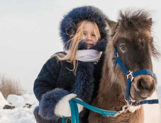 Little Girl with Pony in Snow Winter