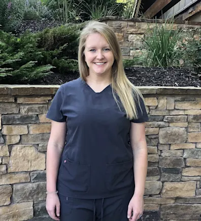 A assistant posing for a photo A assistant posing for a photo