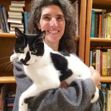 Dr. Angelique Cucaro holding black and white cat