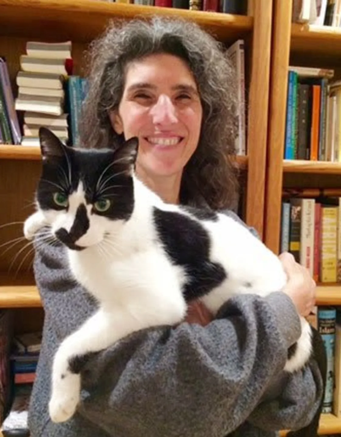 Dr. Angelique Cucaro holding black and white cat Dr. Angelique Cucaro holding black and white cat