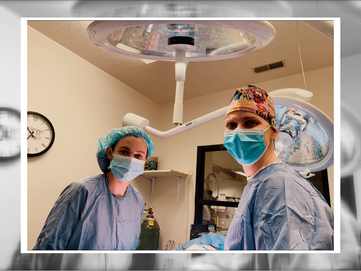 Two veterinarians ready for surgery.