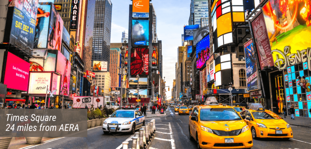 An image of the Times Square with text stating "Times Square 24 miles from AERA".