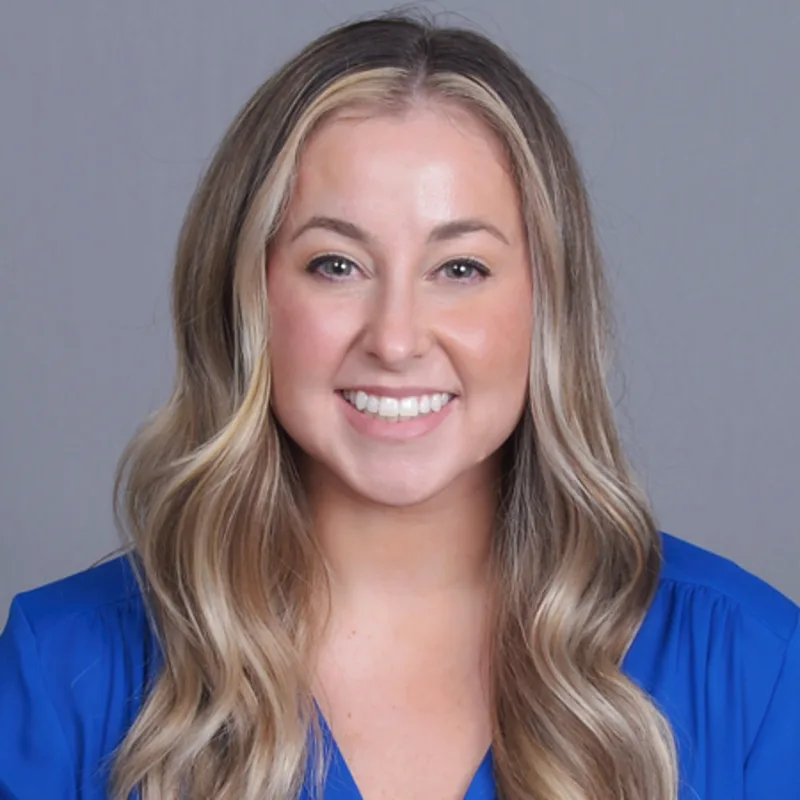 Jillian Sergi smiling in front of a grey wall Jillian Sergi smiling in front of a grey wall