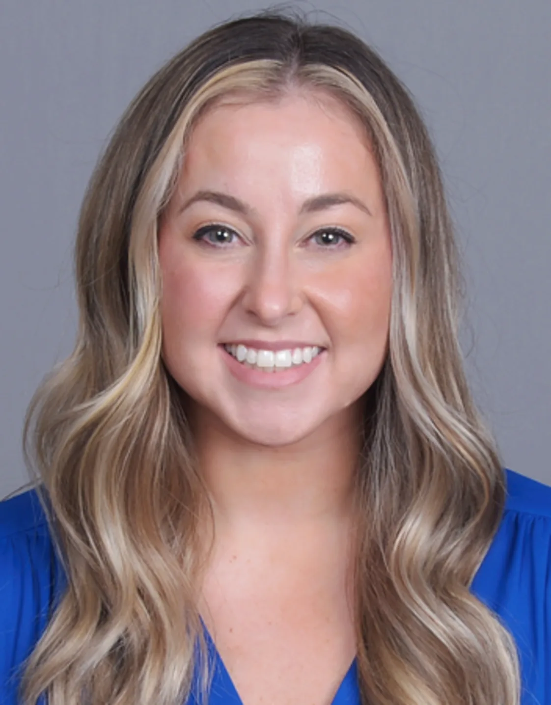 Jillian Sergi smiling in front of a grey wall Jillian Sergi smiling in front of a grey wall