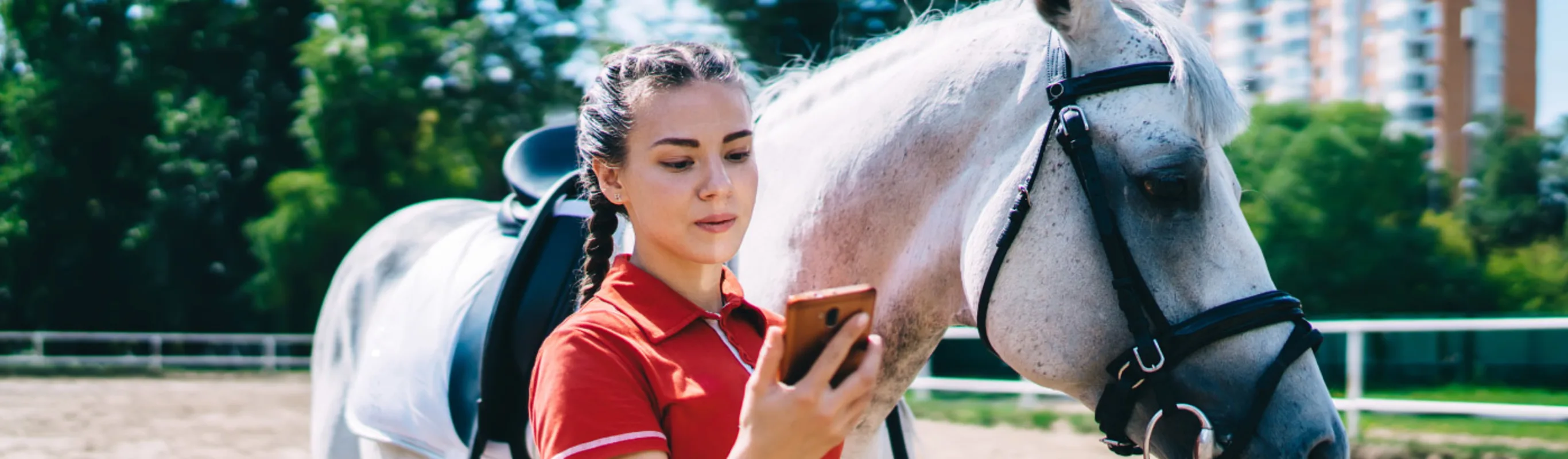 Girl with her cell phone and a horse