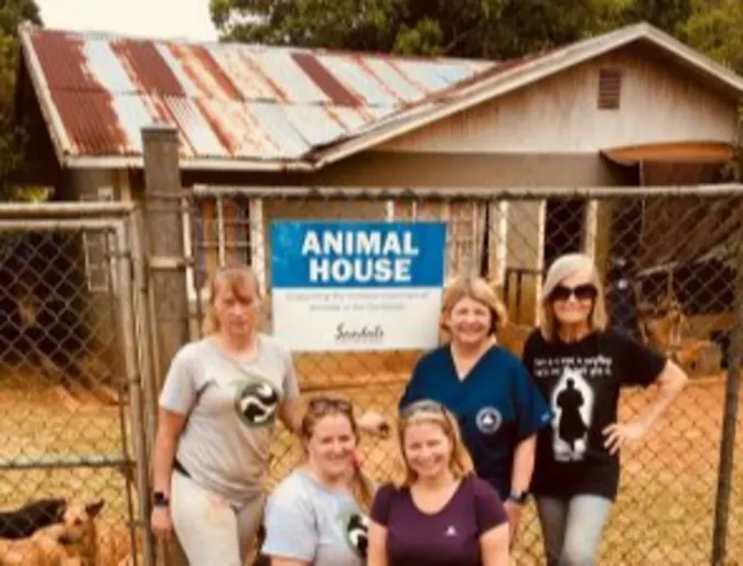 A group of Allandale's staff posing in front of an animal house in Jamaica A group of Allandale's staff posing in front of an animal house in Jamaica