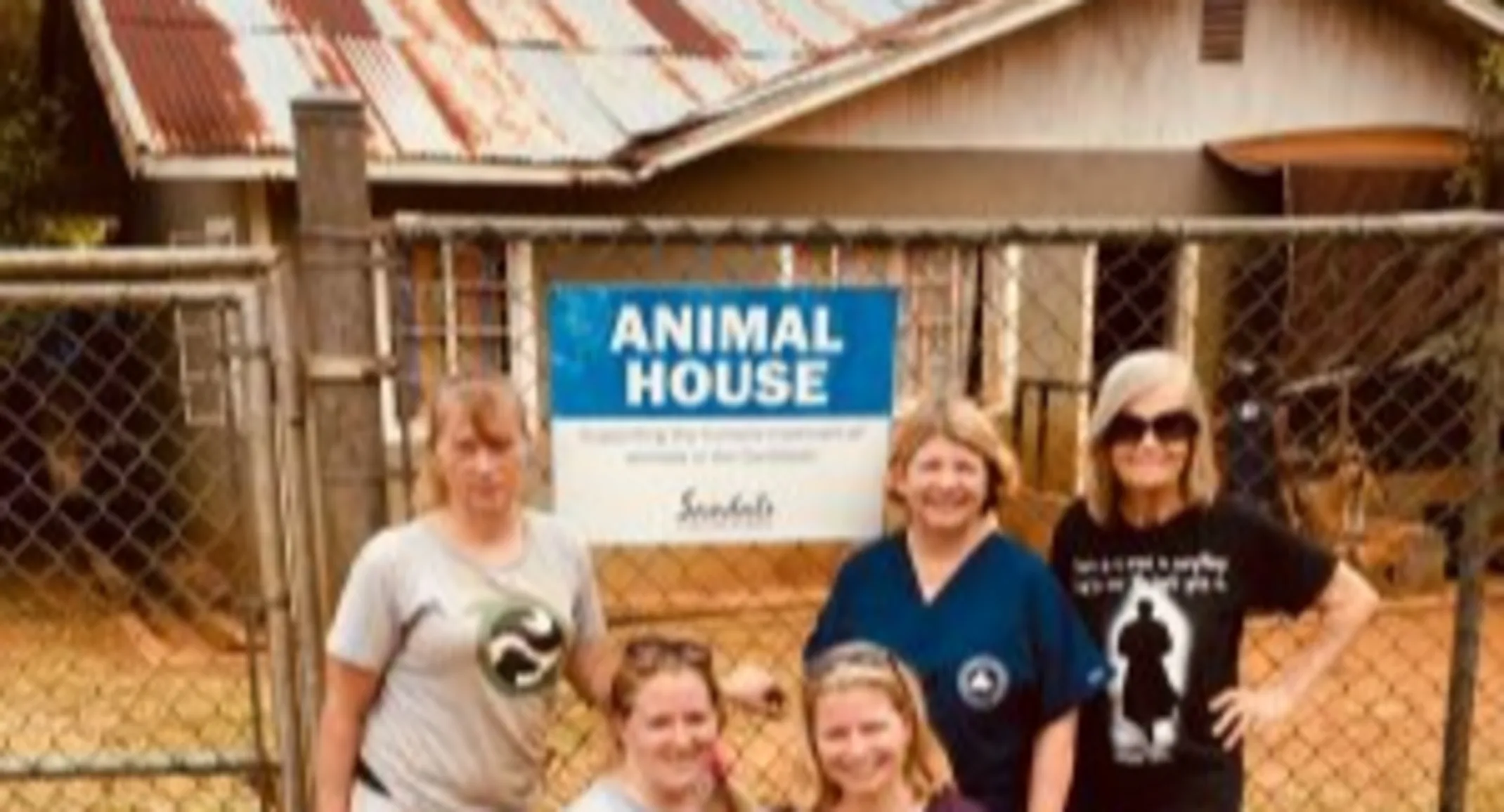 A group of Allandale's staff posing in front of an animal house in Jamaica A group of Allandale's staff posing in front of an animal house in Jamaica