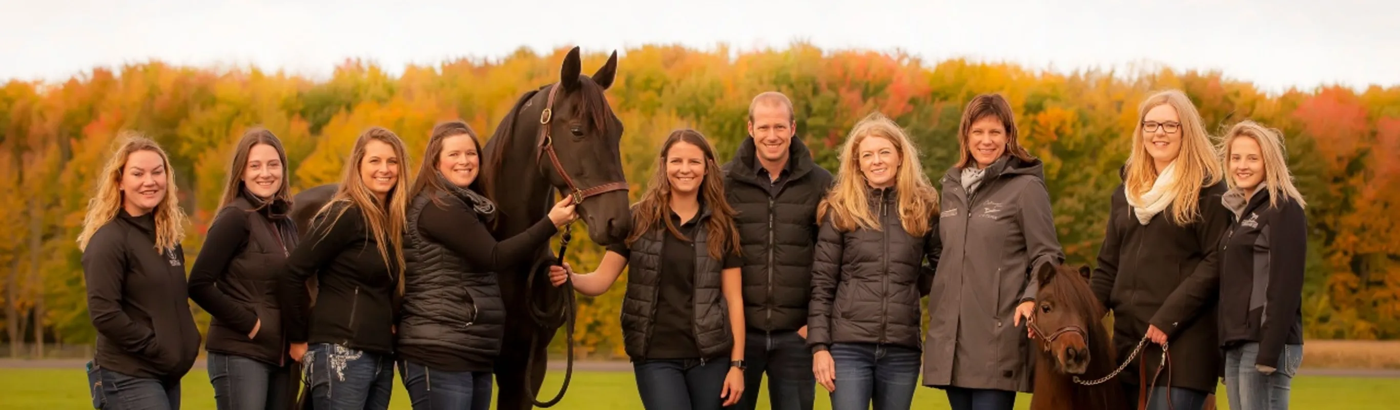 Russell Equine Veterinary Service staff standing outside with a horse behind the location sign. Russell Equine Veterinary Service staff standing outside with a horse behind the location sign.
