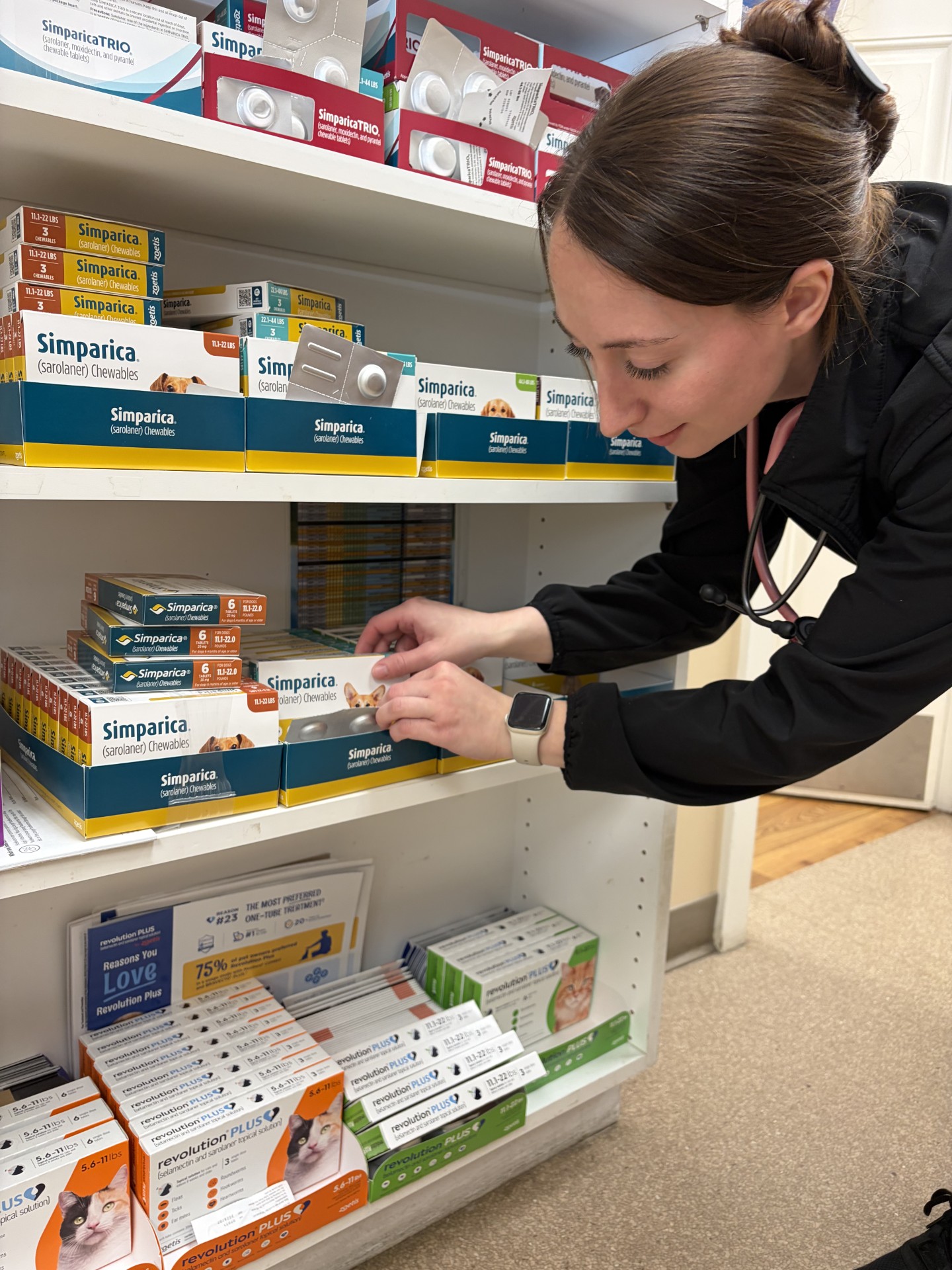 A woman looking through her pharmacy