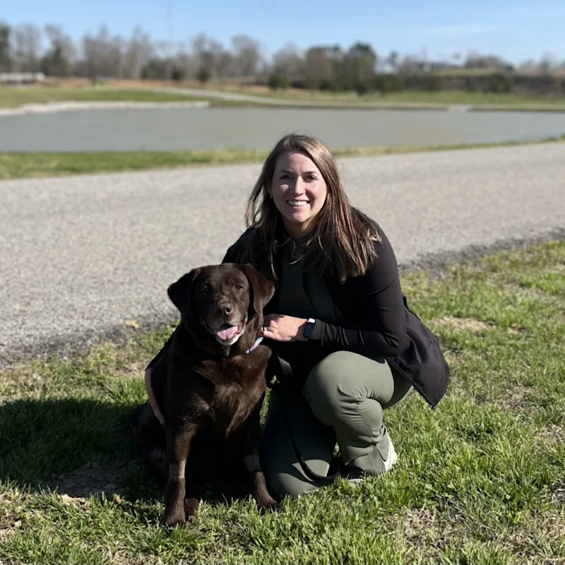 Kendall sliming kneeling down next to a dog Kendall sliming kneeling down next to a dog