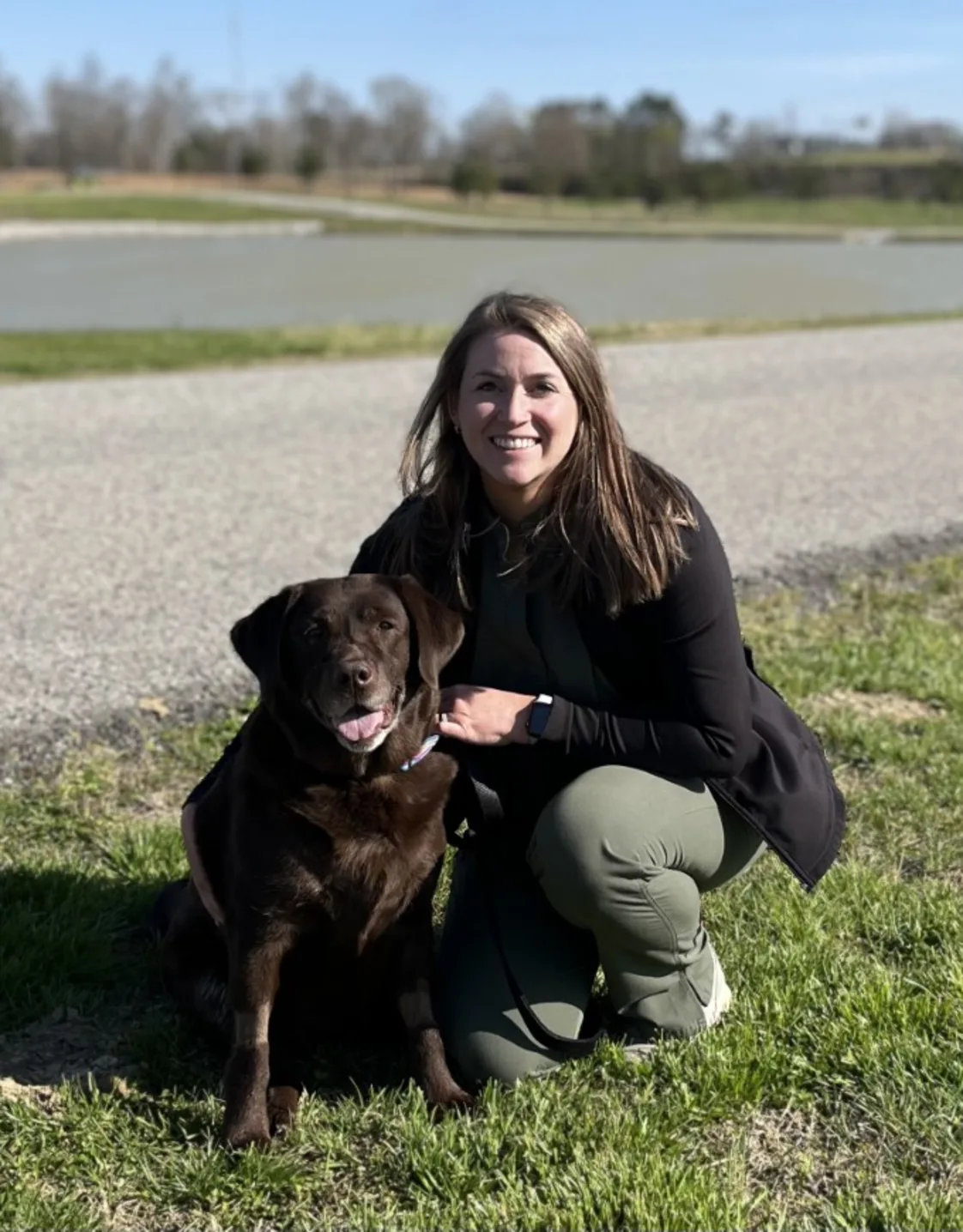 Kendall sliming kneeling down next to a dog Kendall sliming kneeling down next to a dog