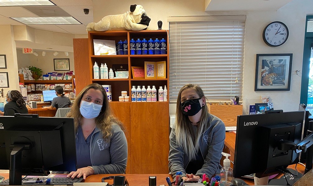 Two receptionists at the check-in desk.
