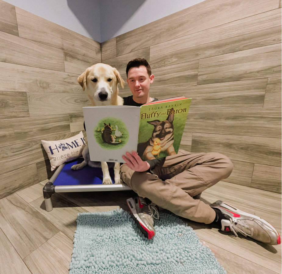 Staff reading to lab in luxury suite.