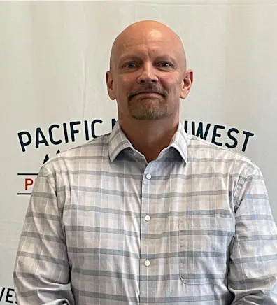 A photo of Dr. Chauvin smiling and holding multiple newborn puppies A photo of Dr. Chauvin smiling and holding multiple newborn puppies
