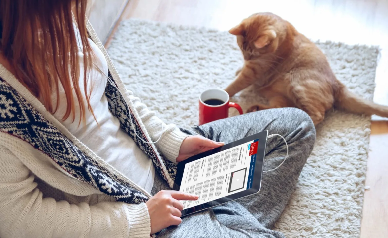 Woman reading newsletter with her cat Woman reading newsletter with her cat