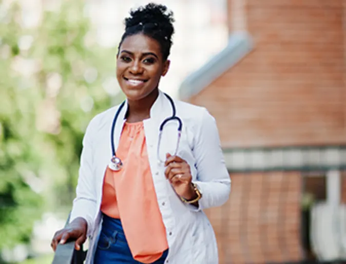 Female veterinarian standing outside on a porch