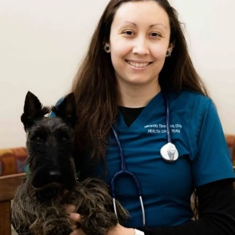 Dr. Timmons with dog. Dr. Timmons with dog.