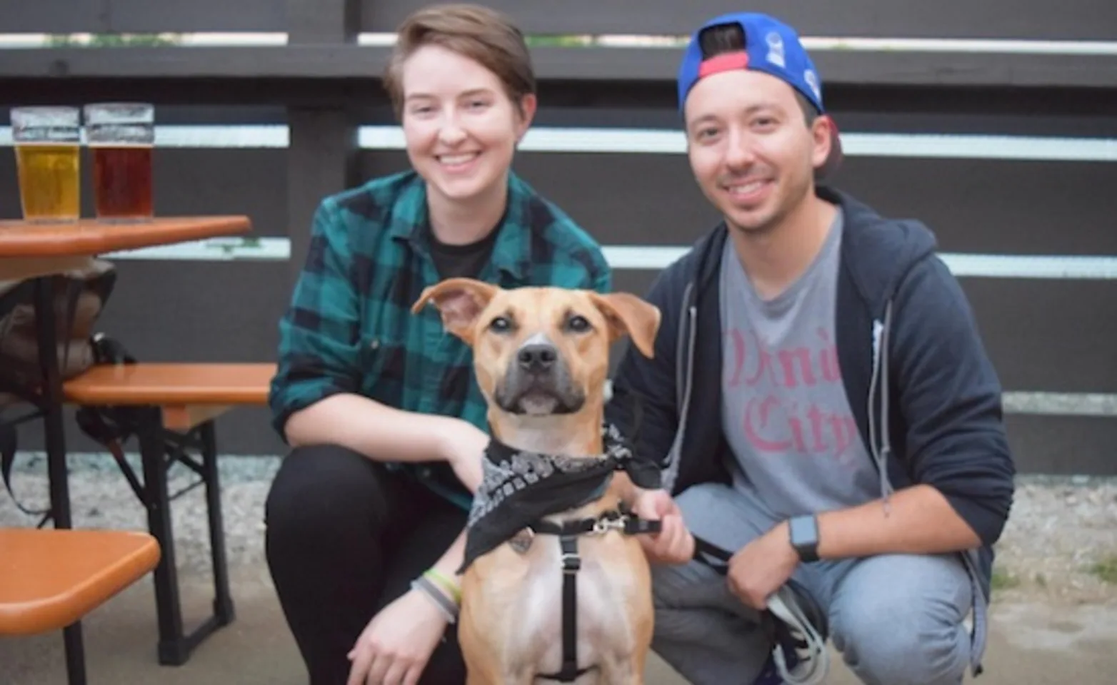 Two owners and their dog