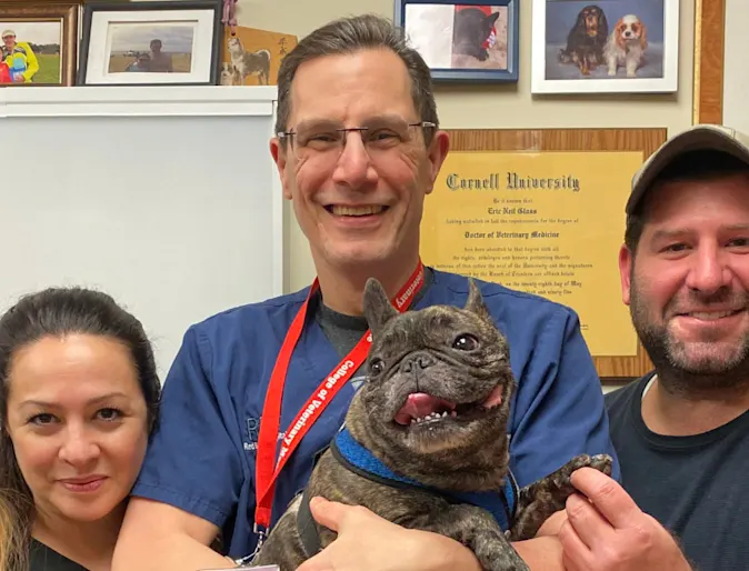 Dr. Glass with his dog patient and its owner Dr. Glass with his dog patient and its owner