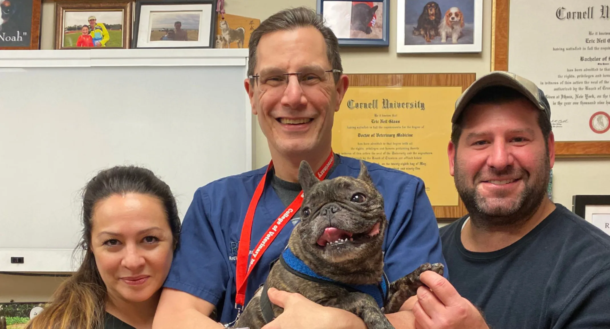 Dr. Glass with his dog patient and its owner Dr. Glass with his dog patient and its owner