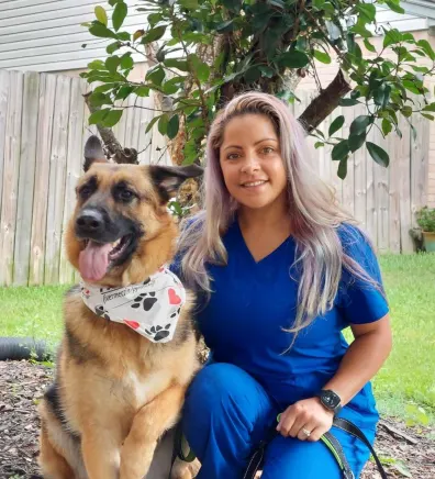 Christina with a brown dog at Stuebner Airline Veterinary Hospital