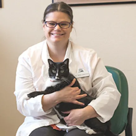 Dr. Sarah Bangtson sitting while holding cat