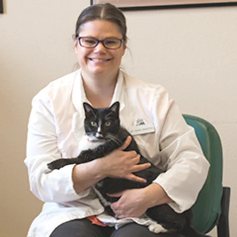 Dr. Sarah Bangtson sitting while holding cat Dr. Sarah Bangtson sitting while holding cat